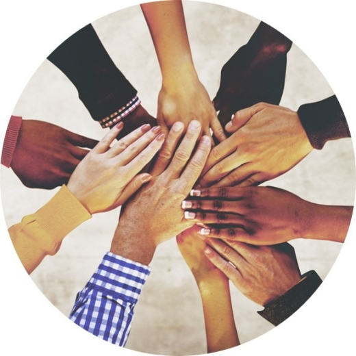 Many hands coming together in middle of image